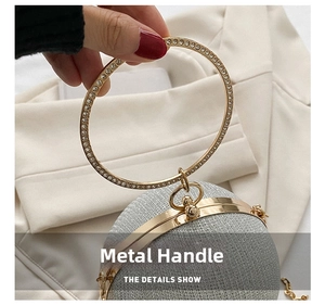 Close-up of a silver glitter evening ball bag with diamond-studded metal ring handle