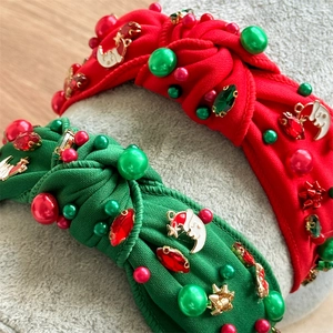 Detailed close-up of Christmas knotted headbands with rhinestones and holiday charms