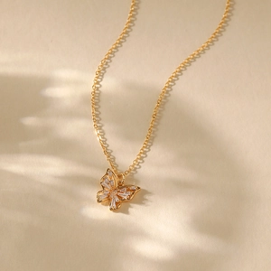 Close-up of 18K gold plated necklace with hollow butterfly pendant and zircon stones