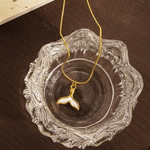 Elegant gold fishtail necklace with shell inlay on a delicate snake bone chain