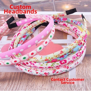Close-up of floral and plaid fabric headbands set with non-slip ends on wooden surface