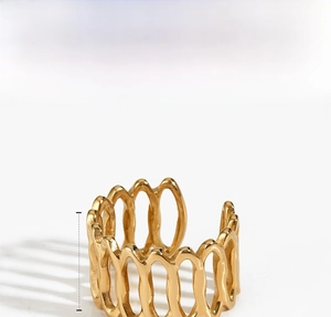 Close-up of golden geometric hollow stripe ring featuring a 14mm wave pattern design