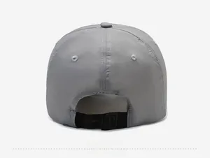Detail view of the adjustable black plastic buckle and grey fabric on baseball cap back
