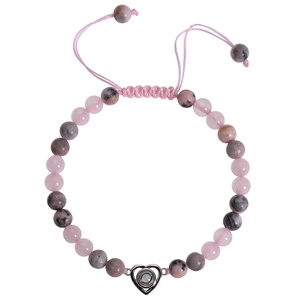 Macro view of 6mm beaded bracelet with heart projection pendant and adjustable pink cord