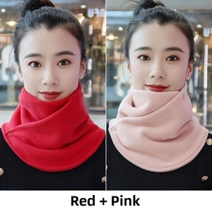 Detail view of red and pink thermal fleece neck warmers with button closure for winter