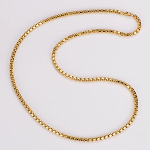 Macro shot of flexible golden box chain necklace design on a clean white background