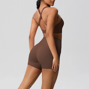 Detail of cross-back yoga bra and high-waist shorts in matte coffee brown fabric