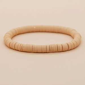 Detailweergave van de bohemien perzikroze heishi-kralenarmband van klei voor dames