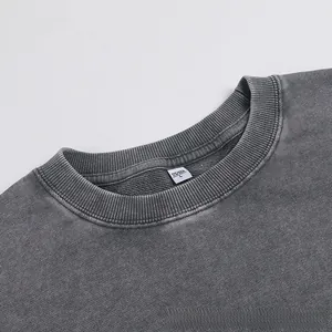 Detailed macro view of the ribbed neckline and size tag on a vintage washed oversized sweatshirt