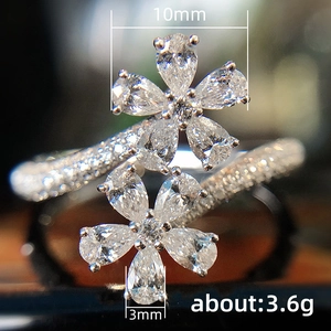 Sparkling bypass flower ring with pear-cut cubic zirconia and pavé diamond band