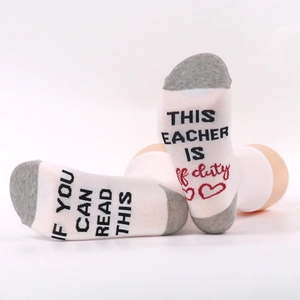 Detail of knit socks sole with If You Can Read This Teacher Is Off Duty message