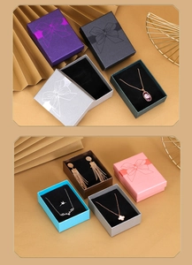 Detail of colorful jewelry gift boxes with bow prints and sponge padding for necklaces