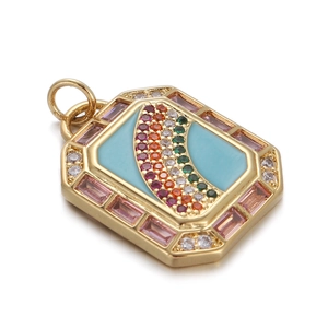 Macro view of gold rectangular pendant with blue enamel, rainbow gems and pink crystals