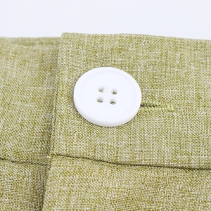 Women's green linen two-piece set featuring waist detail and white button closure