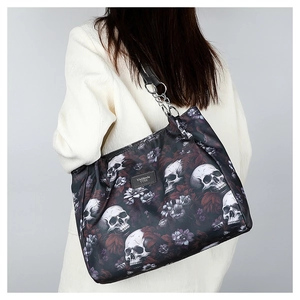 Detail of floral skull pattern on black oxford nylon bag with metal chain strap