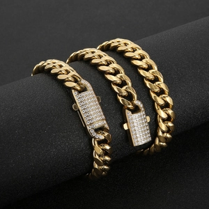 Detail of gold Cuban link chain with luxury iced-out diamond clasp on black display