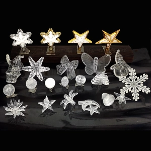 Macro shot of assorted transparent acrylic Christmas light covers in star and snowflake shapes