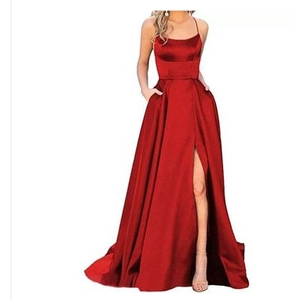 Elegant red satin evening gown with thin straps and a thigh-high slit on a white background