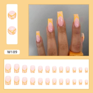 Medium square false nails with light pink base and irregular yellow flame patterns