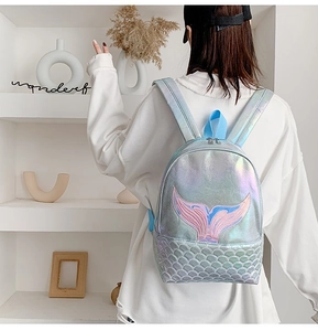 Detail of mermaid tail embroidery and iridescent laser fabric on the student backpack