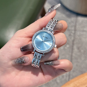 Elegant women's watch with silver steel strap, blue sunray dial and sparkling rhinestones