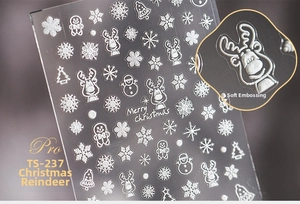 Macro detail of 5D white embossed Christmas nail stickers featuring snowflakes and reindeer