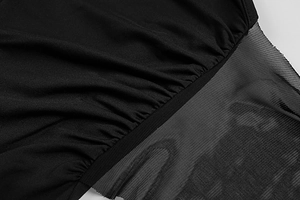Detail view of black knit and mesh patchwork dress with intricate ruched stitching