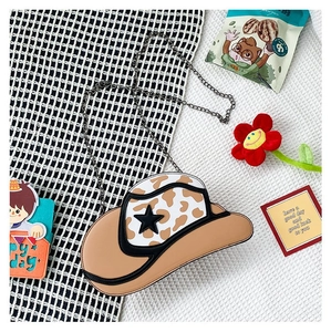 Detail of cowboy hat-shaped crossbody bag with leopard print and black star accent