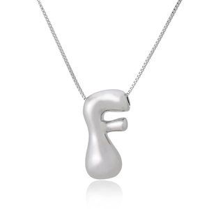 Detailed view of silver puffed letter F pendant with polished box chain and mirror reflection