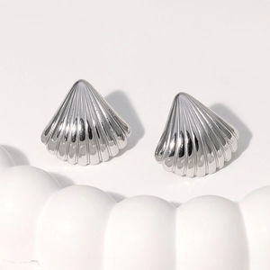 Polished silver shell stud earrings in 18K gold plated stainless steel on wavy surface