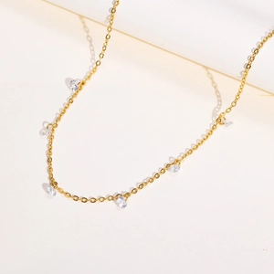 Detail of gold-plated stainless steel chain necklace featuring sparkling zircon charms