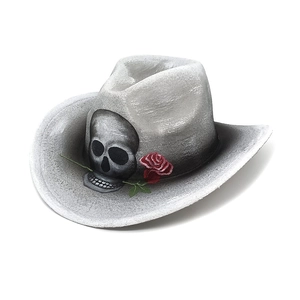 Macro detail of a grey cowboy hat featuring a black skull with a red rose and gothic texture