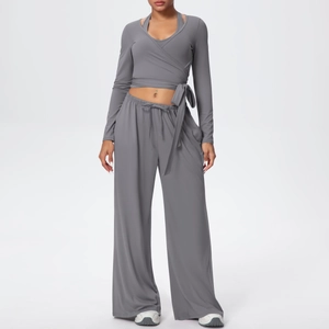 Détail de l'ensemble de yoga 3 pièces gris foncé avec haut cache-cœur et pantalon large