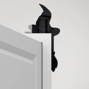 Black acrylic witch silhouette decal on white door corner for Halloween decor