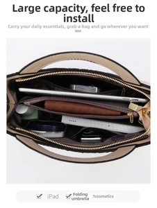 Detail view of the beige crocodile pattern tote bag with spacious multi-compartment interior