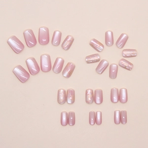 Detailed view of pink cat-eye press-on nails with golden marble texture and pearl finish