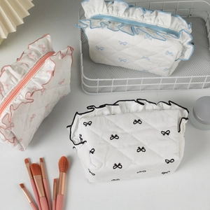 Quilted cotton cosmetic bags with lace bow patterns and ruffled edges in a 3-piece set