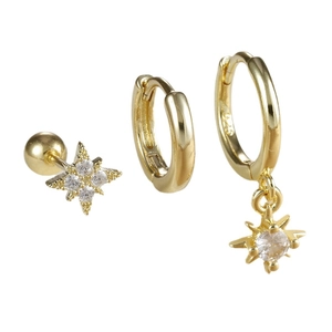 Set of three gold star-shaped earrings with sparkling cubic zirconia on white background