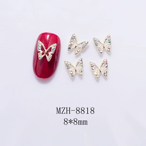 Detail of 8x8mm gold metal 3D butterfly nail charms with AB crystals and red nail art sample