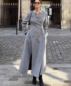 Detail of the unique diagonal double-breasted buttons on this long grey wool coat