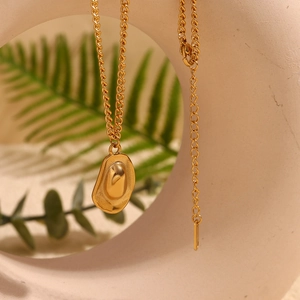 Detail of 18K gold-plated irregular oval pendant necklace with a fine adjustable chain