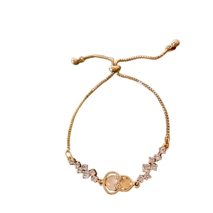Adjustable gold bracelet with zircon hulu pendant and faux cat-eye stones for women