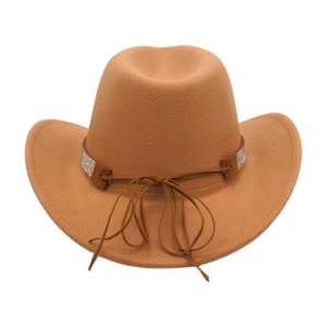 Detail of tan felt cowboy hat featuring rhinestone band and curved brim on white background