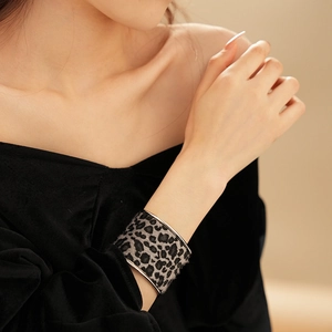 Detailed close-up of wide leopard print velvet cuff bracelet with silver metal edges
