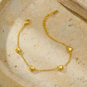 Minimalist 18K gold plated stainless steel heart charm bracelet on white stone
