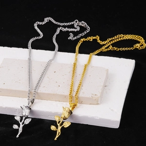 Detailed view of 3D rose pendants in gold and silver finish on elegant stone props