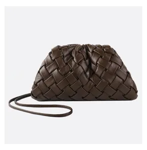 Close-up of dark brown woven leather cloud bag with premium pleated texture and strap
