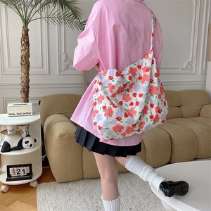 Floral canvas tote bag with large capacity shown in a stylish lifestyle setting