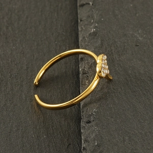 Macro detail of 18k gold ginkgo leaf open ring with sparkling heart shaped zircons