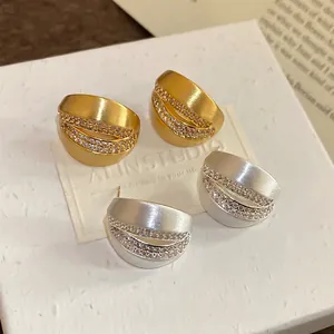 18K brushed metal C-shaped stud earrings with zircon inlay in gold and silver